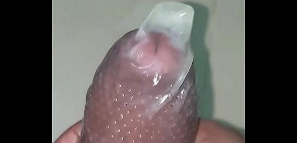  Indian man cums in a dotted condom